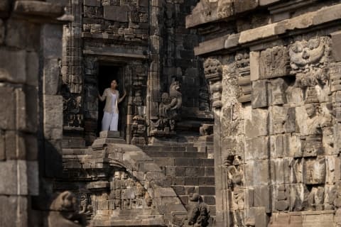 Kotagede A person standing in a doorway of a stone building Garrya Indonesia cultural heritage