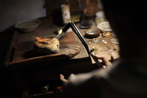 indonesia garrya bianti yogyakarta cultural craft silver making person holding a torch over a rock