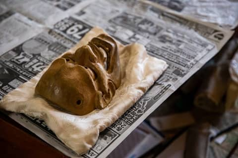 banyan tree higashiyama kyoto traditional japanese noh wooden mask on a piece of cloth on top of newspaper